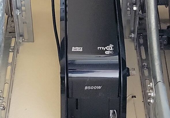 Modern smart garage door opener system in a stylish suburban home, controlled via smartphone.