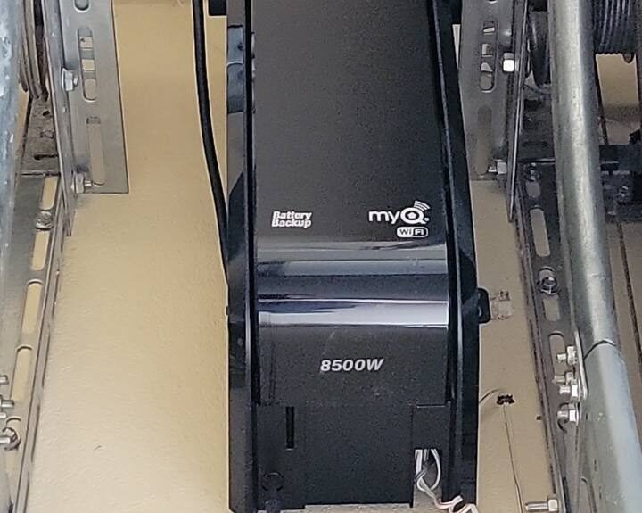 Modern smart garage door opener system in a stylish suburban home, controlled via smartphone.