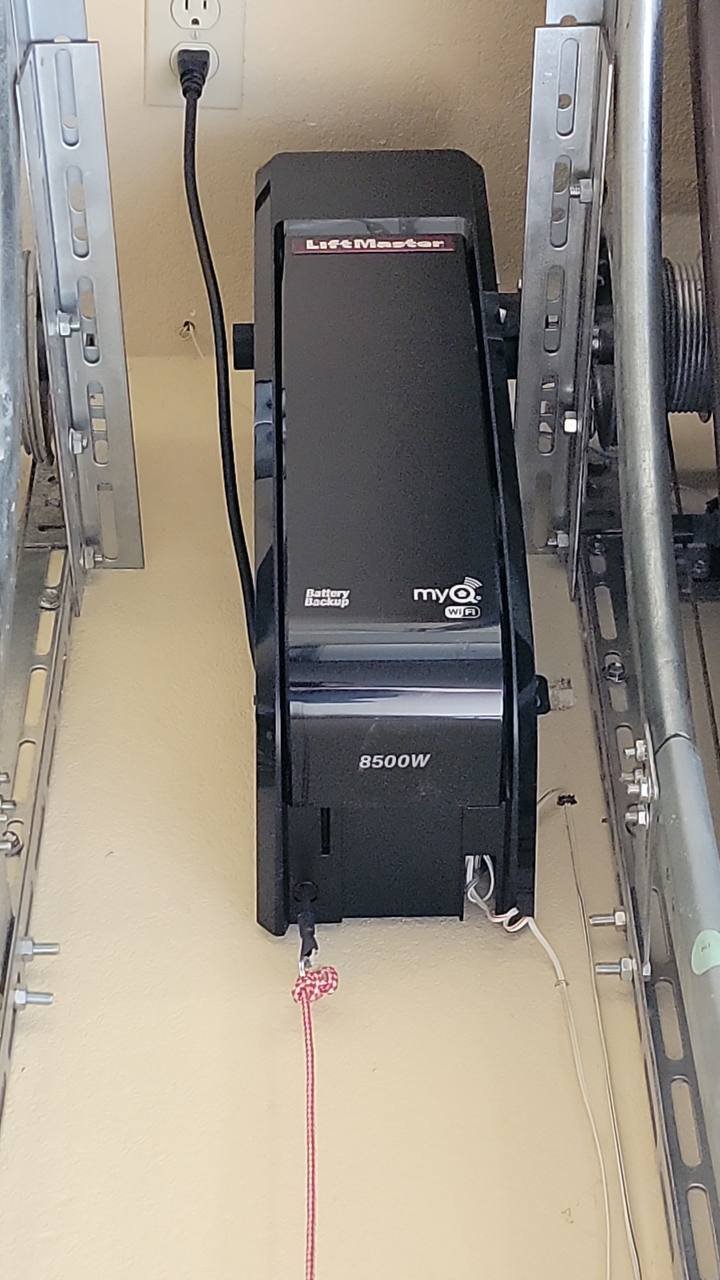 Modern smart garage door opener system in a stylish suburban home, controlled via smartphone.